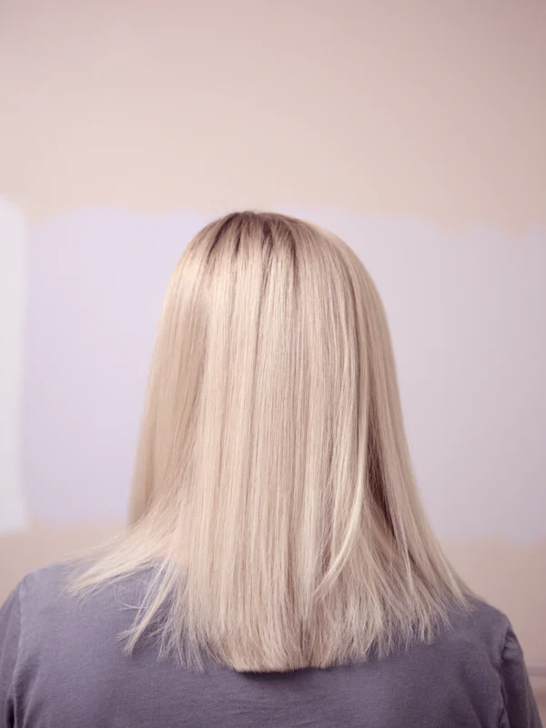 A sleek, straight blonde bob seen from behind