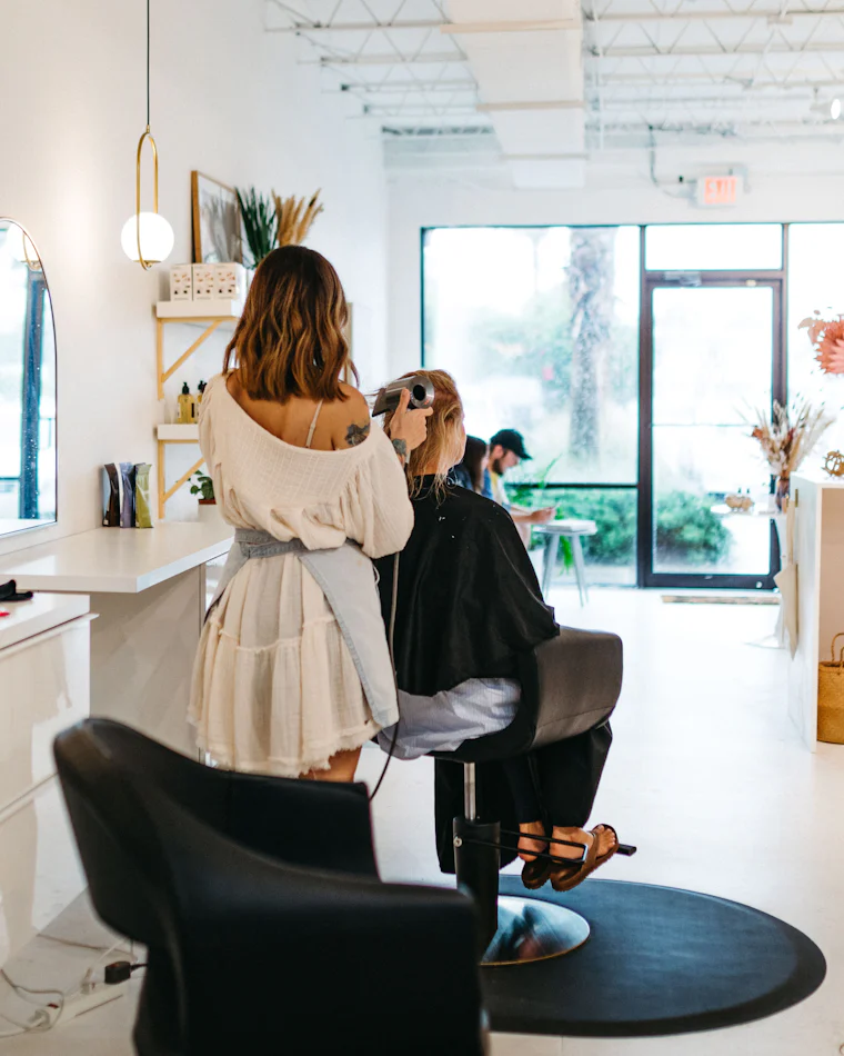 A bright, calm salon interior with a client in the styling chair
